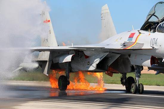 The damaged left engine of J-15 fighter Flying Shark catches fire on landing on the ground. [Photo: CCTV]