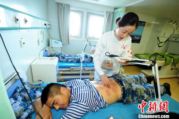 Medical staff on China's naval hospital ship Peace Ark provide health care services to soldiers on the missile frigate Yangzhou on August 16, 2017. [Photo: Chinanews.com]