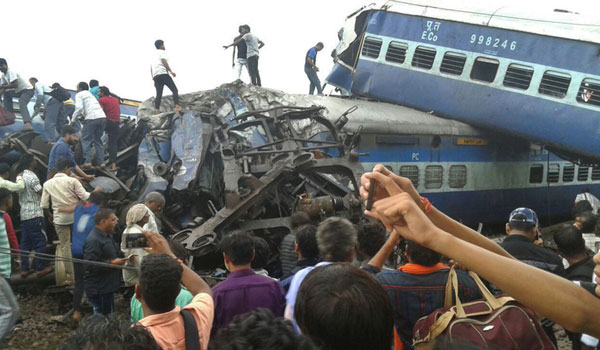 Railway police and local volunteers look for survivors in the upturned coaches of the Kalinga-Utkal Express after an accident near Khatauli, in the northern Indian state of Uttar Pradesh, on August 19, 2017. [Photo: Imagine China]